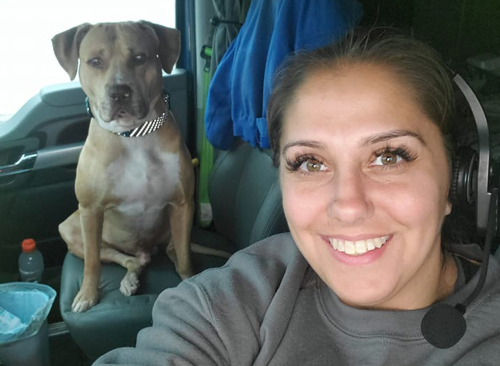 Melton flatbed driver and her dog in the passenger seat