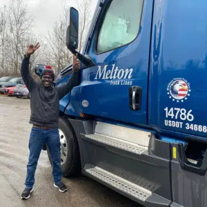 Melton driver celebrating in front of a Melton truck